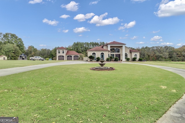 mediterranean / spanish-style home featuring a garage and a front lawn