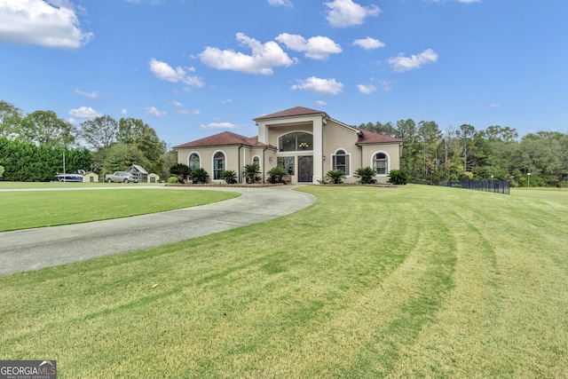 mediterranean / spanish house featuring a front yard