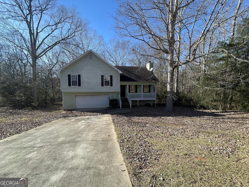 tri-level home with a garage and a porch