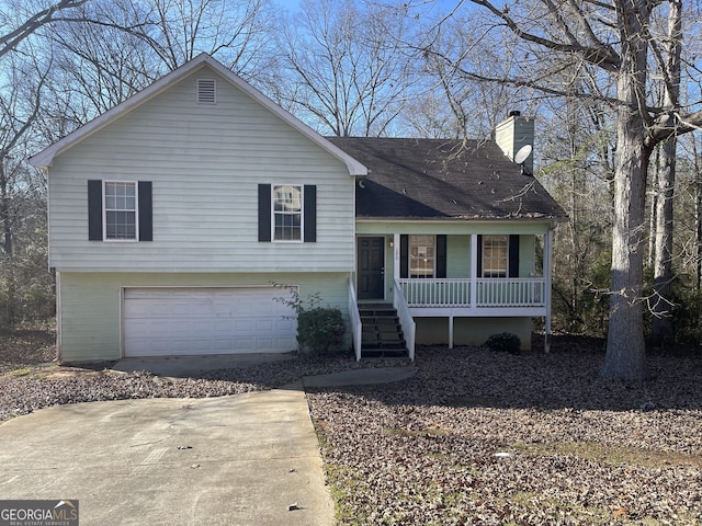 tri-level home with a garage and covered porch