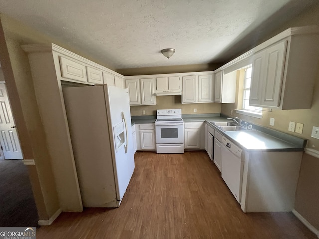 kitchen featuring hardwood / wood-style floors, sink, white cabinets, white appliances, and a textured ceiling