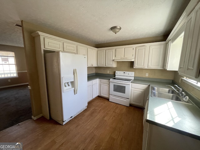 kitchen featuring sink, a textured ceiling, dark hardwood / wood-style floors, white appliances, and white cabinets