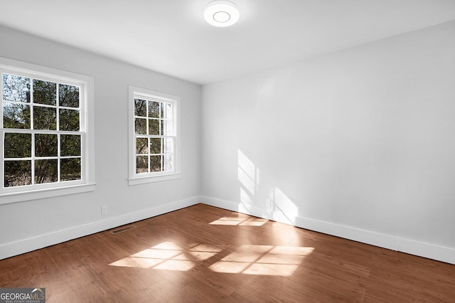 spare room featuring hardwood / wood-style floors