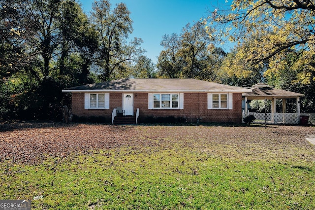 ranch-style home featuring a front yard