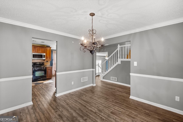 unfurnished dining area with dark hardwood / wood-style flooring, ornamental molding, a textured ceiling, and an inviting chandelier