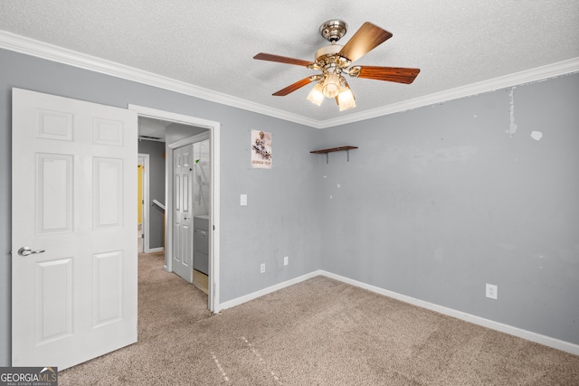 carpeted empty room with ornamental molding, ceiling fan, and a textured ceiling