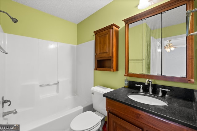 full bathroom with  shower combination, vanity, a textured ceiling, and toilet