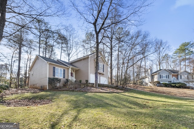 view of front of property featuring a garage and a front yard