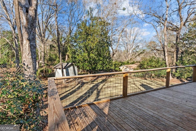 wooden terrace featuring a shed