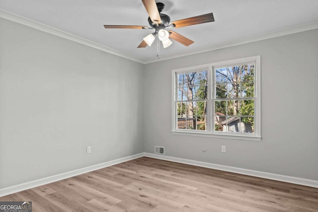 unfurnished room with crown molding, ceiling fan, and light wood-type flooring