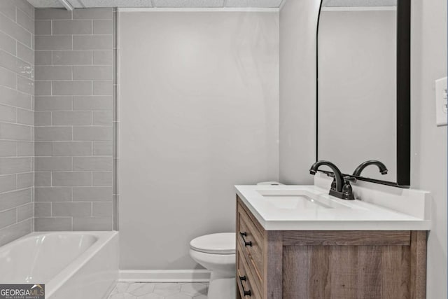 full bathroom with vanity, tiled shower / bath, and toilet