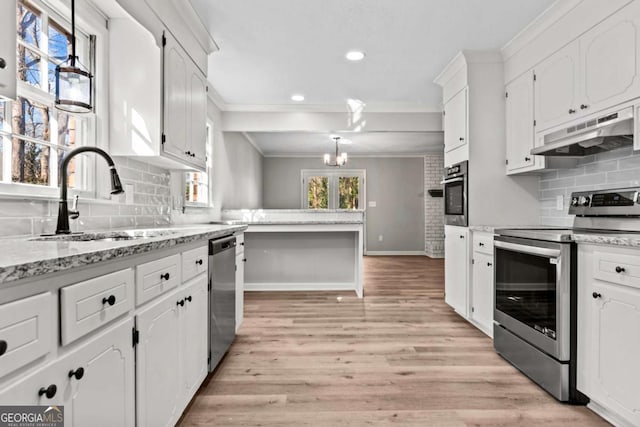 kitchen with white cabinetry, hanging light fixtures, sink, and appliances with stainless steel finishes