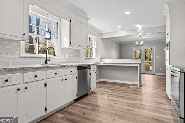 kitchen featuring ornamental molding, white cabinets, and appliances with stainless steel finishes