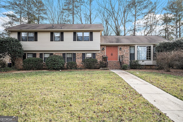 tri-level home with a front yard