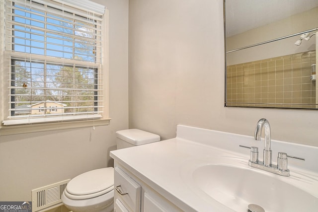 bathroom featuring vanity and toilet