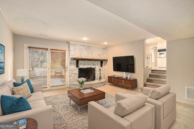 carpeted living room featuring a fireplace