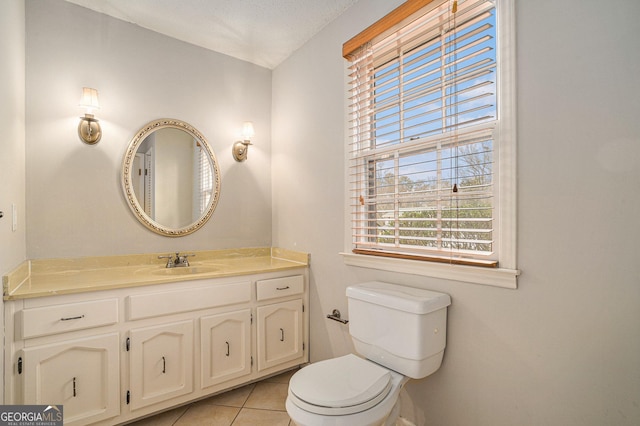 bathroom featuring tile patterned flooring, vanity, and toilet