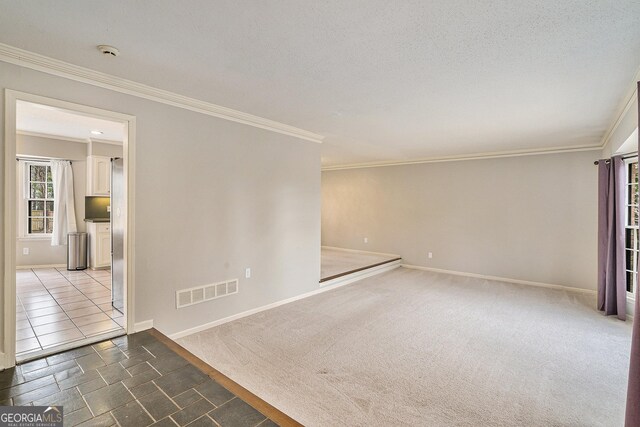 unfurnished room with ceiling fan, light colored carpet, and a textured ceiling