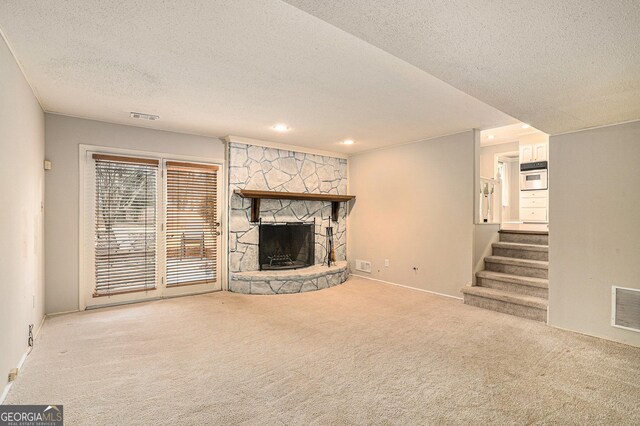 basement featuring light carpet and a textured ceiling