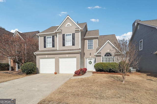 view of property with a garage and a front yard