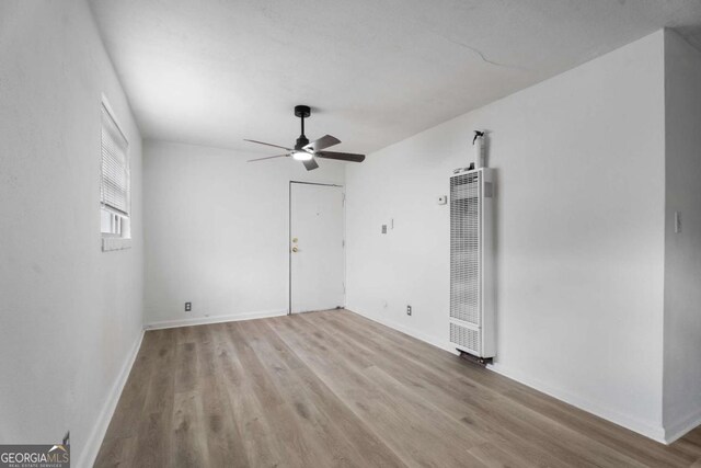 empty room featuring ceiling fan and light wood-type flooring