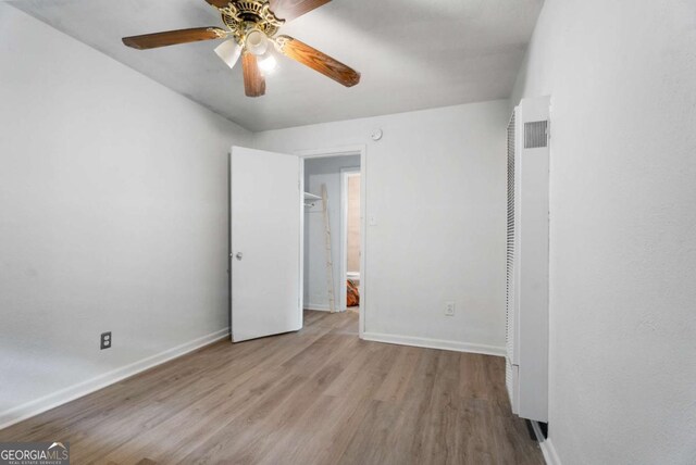 unfurnished bedroom featuring ceiling fan and light hardwood / wood-style flooring