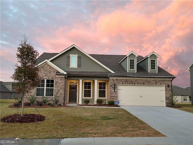 view of front of property with a garage and a yard