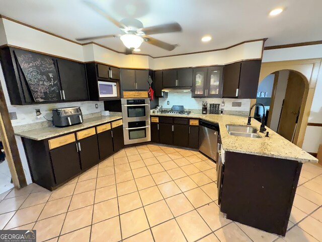 kitchen featuring sink, light tile patterned floors, kitchen peninsula, stainless steel appliances, and light stone countertops