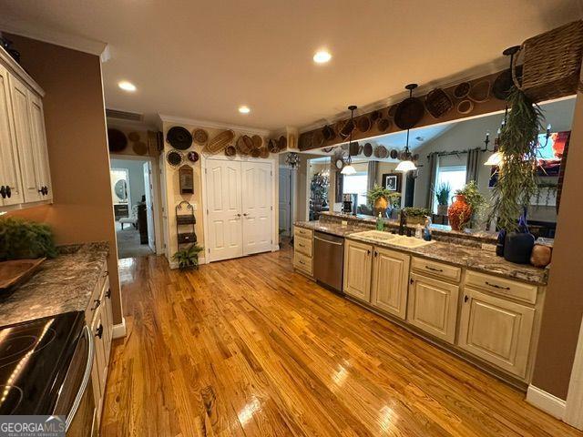 living room with high vaulted ceiling, light hardwood / wood-style flooring, and a notable chandelier