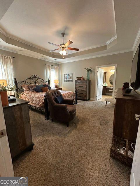 carpeted bedroom featuring a raised ceiling, crown molding, and ceiling fan