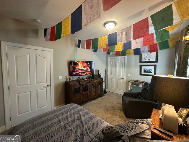 carpeted bedroom with a fireplace