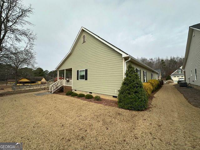 view of property exterior featuring a lawn