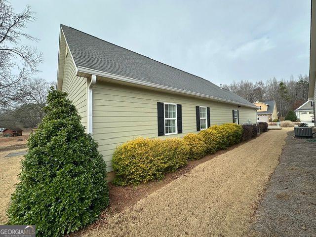 view of side of property featuring central AC