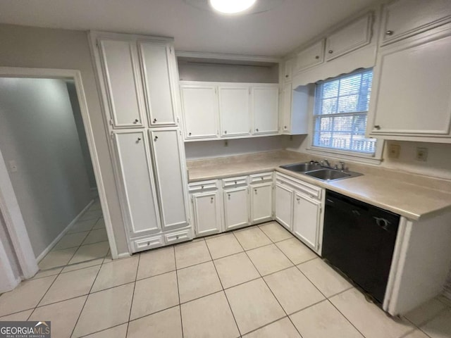 kitchen with black dishwasher, white cabinetry, light countertops, and a sink