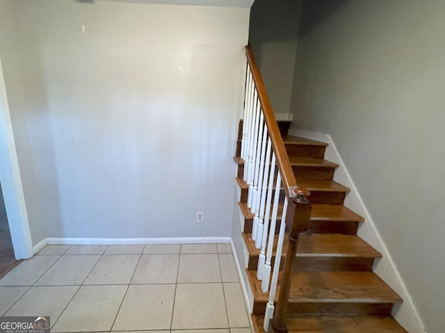 staircase with tile patterned flooring and baseboards