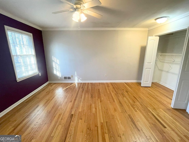 unfurnished bedroom featuring ornamental molding, visible vents, light wood-style flooring, and baseboards