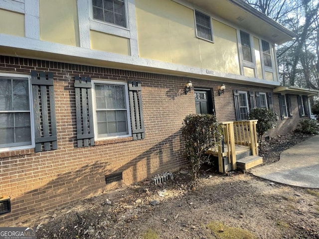 exterior space with crawl space and brick siding