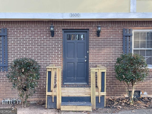 property entrance featuring brick siding