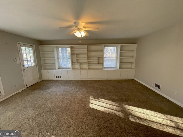 interior space with a ceiling fan, carpet flooring, visible vents, and baseboards