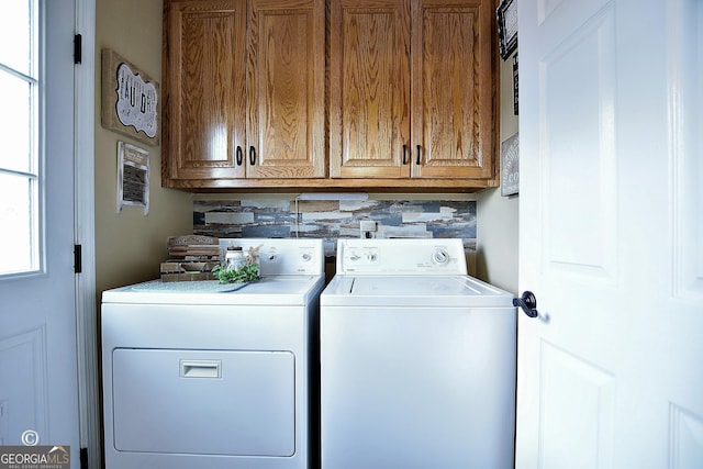 washroom with separate washer and dryer and cabinets