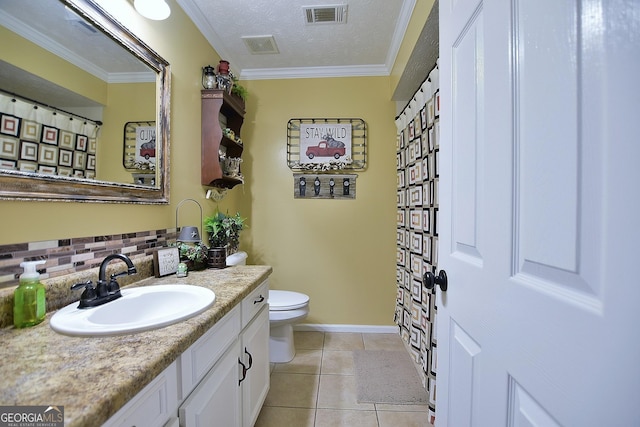 bathroom with vanity, ornamental molding, toilet, tile patterned floors, and a textured ceiling