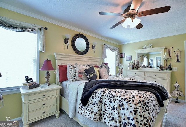 carpeted bedroom with crown molding, ceiling fan, and a textured ceiling