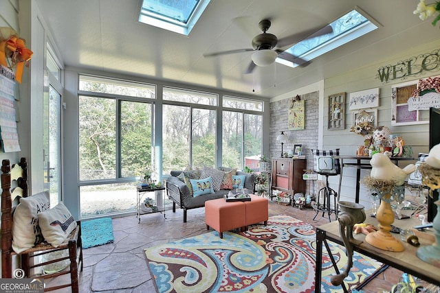 sunroom / solarium with a wealth of natural light, ceiling fan, and a skylight