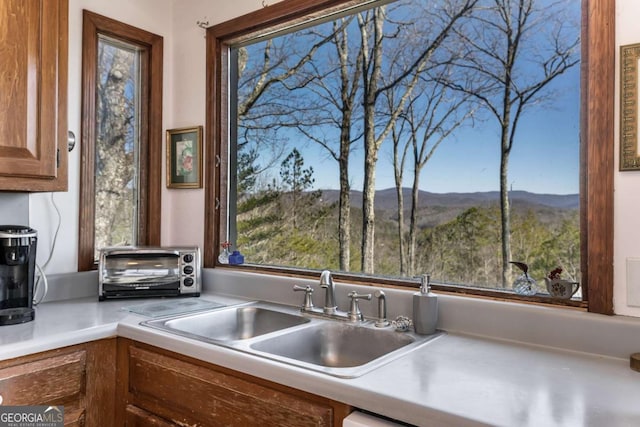 kitchen featuring a mountain view and sink