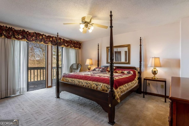 bedroom with a textured ceiling, carpet, and access to outside