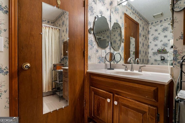 bathroom with vanity, a textured ceiling, and a shower with shower curtain