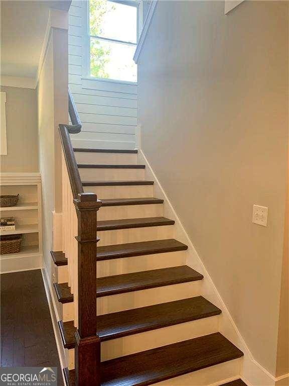 staircase featuring wood-type flooring