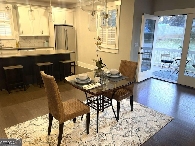 dining room with dark hardwood / wood-style floors and sink