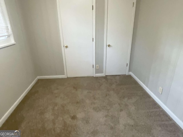 unfurnished bedroom featuring carpet