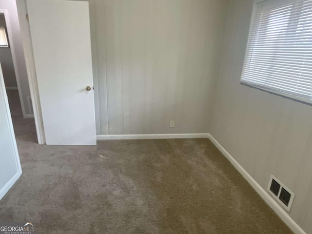 empty room featuring dark carpet